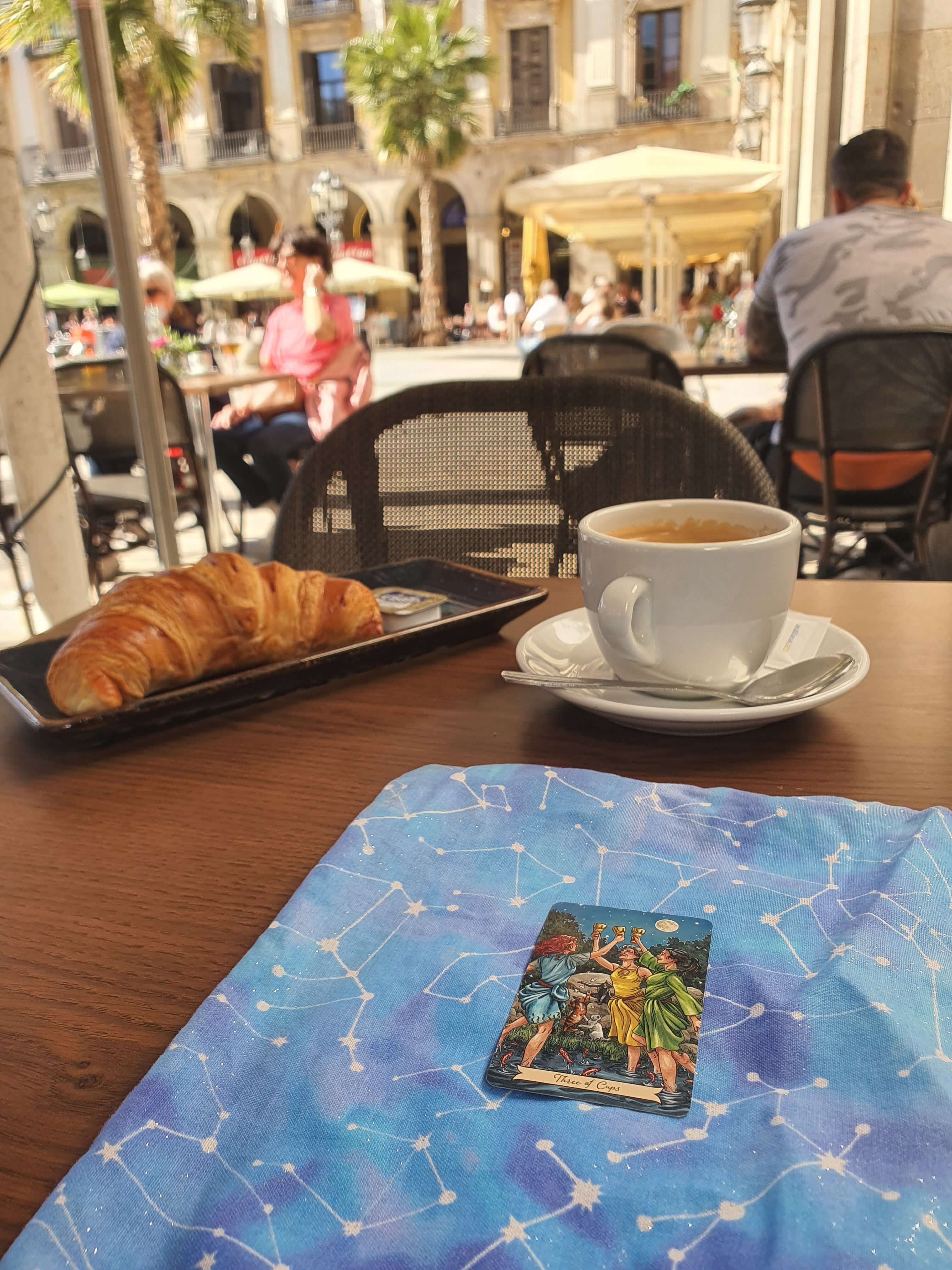Tarot cards, coffee and morning light on Plaça Reial in Barcelona
