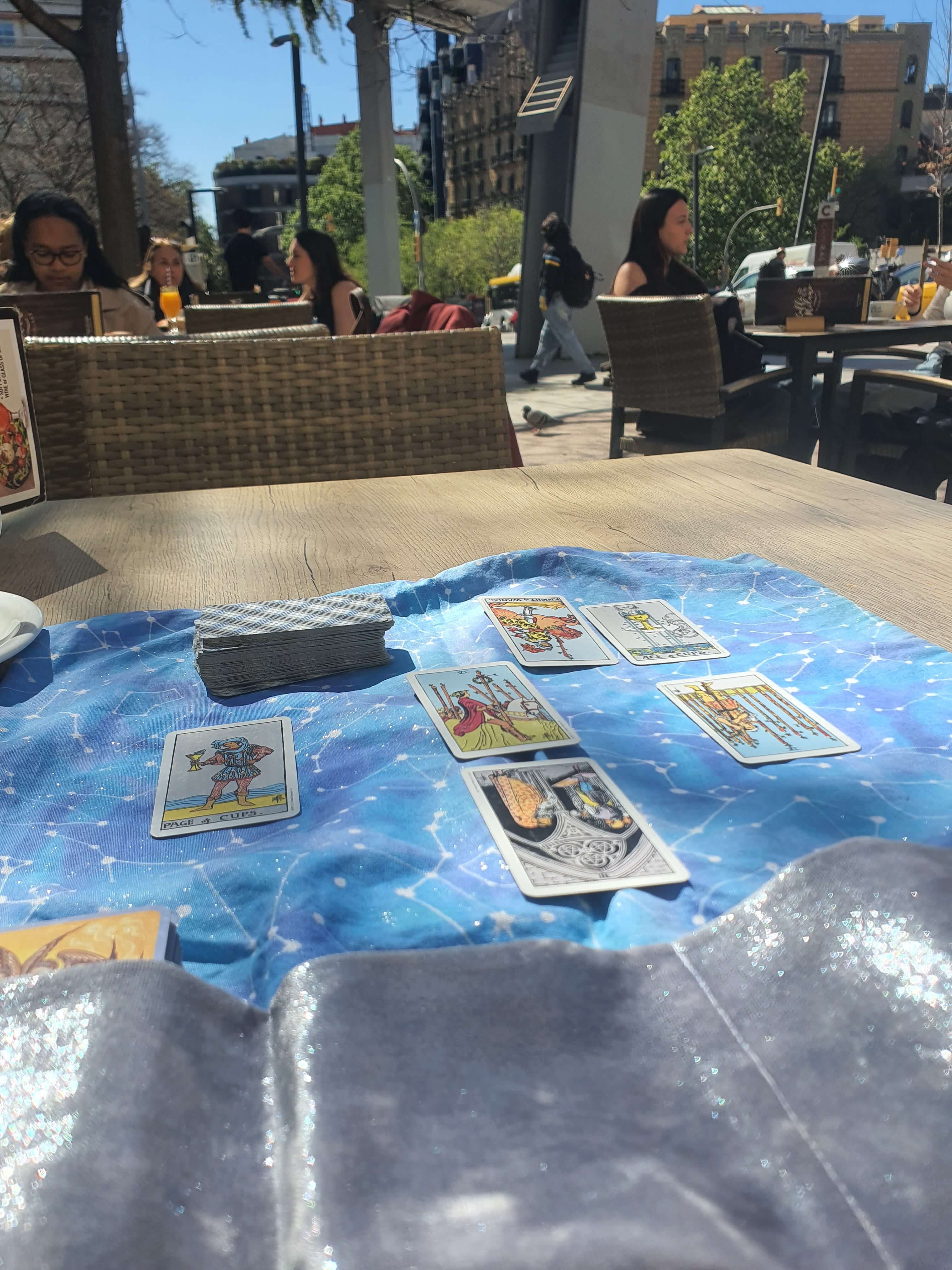 Private Tarot reading setup at a sunny Barcelona coffee shop table