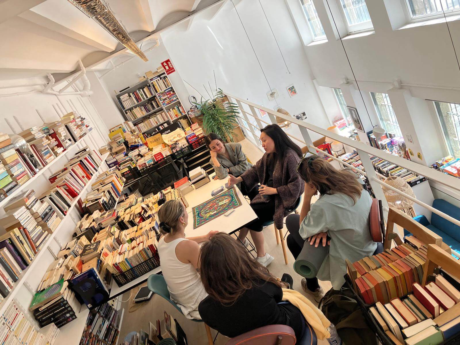 Isabelle sharing an intimate Tarot and Lenormand moment with a group in a beautiful Barcelona bookshop